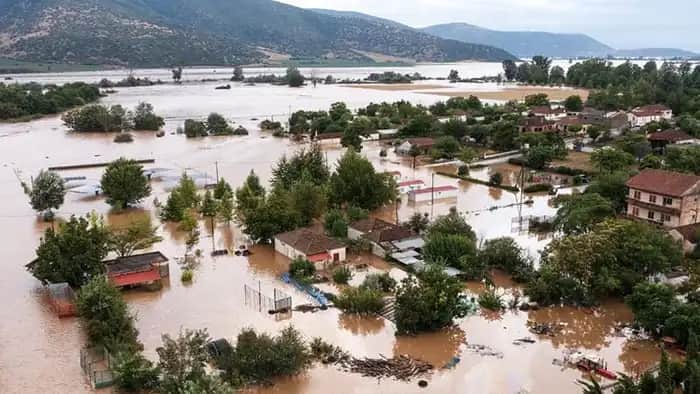 Flood risk management Severe flooding impacting a residential neighborhood near a river, showing urban flood risk